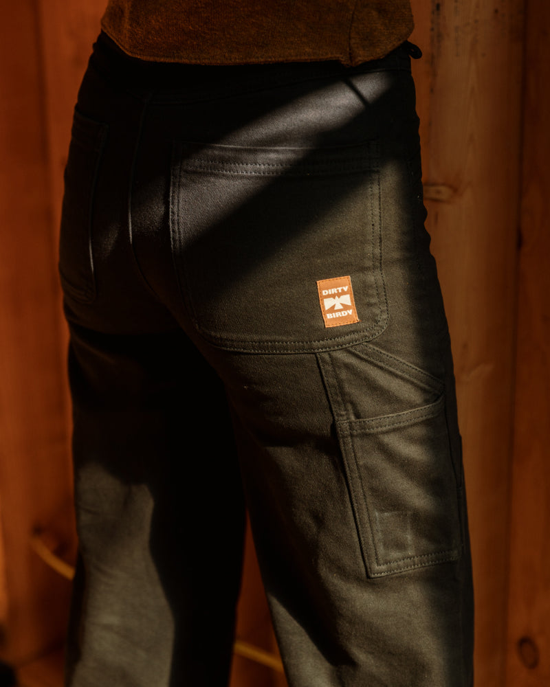 Woman in Dirty Birdy Carpenter Pant on a job site, showcasing that they're durable, tough, and comfortable.